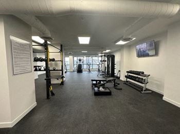 a large fitness room with weights and other equipment